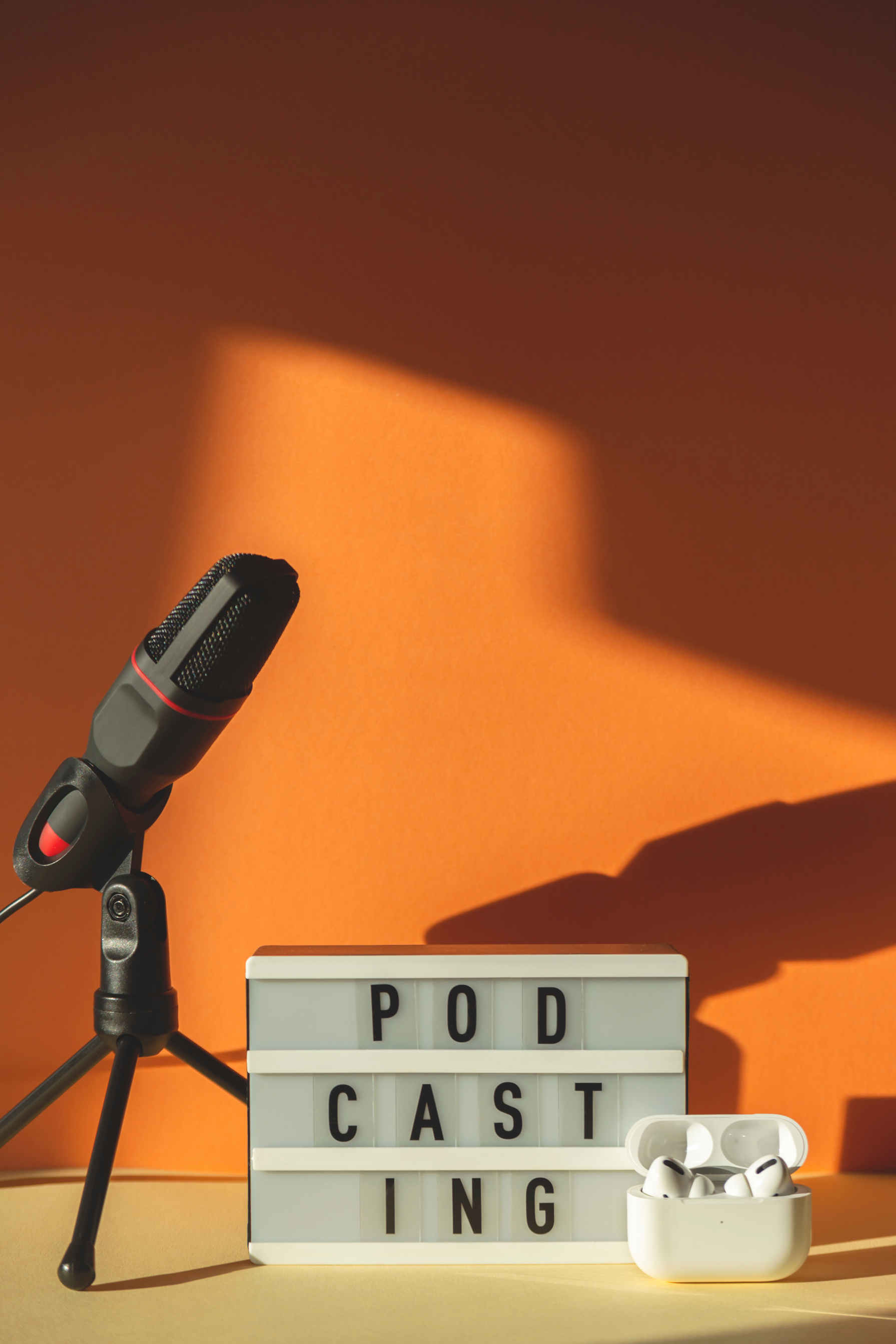 Microphone and Headphones with Podcasting on Lightbox